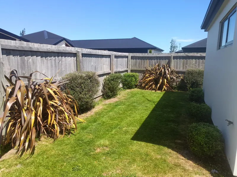 A side garden cleared and mowed after a clean-up, Christchurch